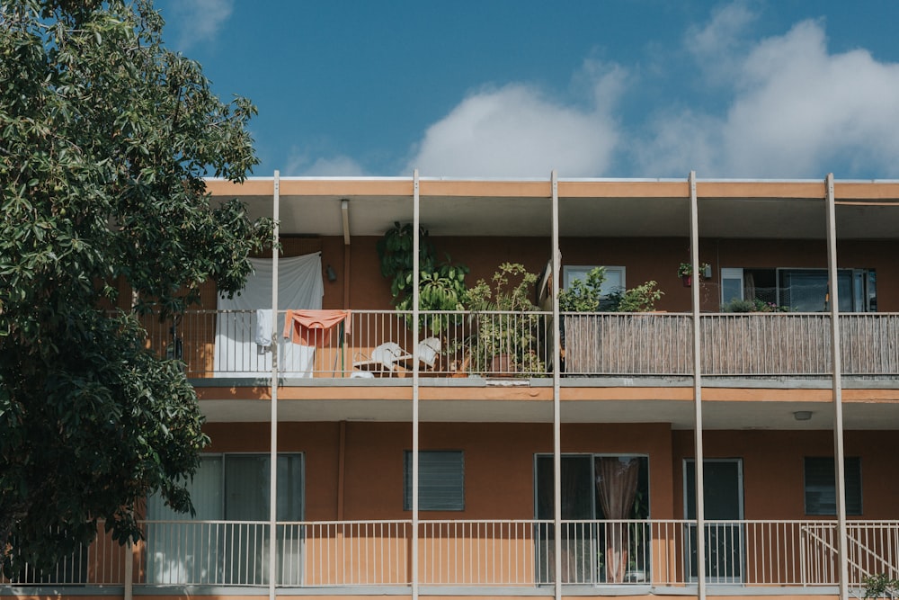 brown paint concrete building beside tree