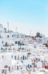A panoramic view of Algiers showcasing whitewashed buildings of the Casbah under a bright blue sky.