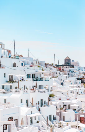 A panoramic view of Algiers showcasing whitewashed buildings of the Casbah under a bright blue sky.