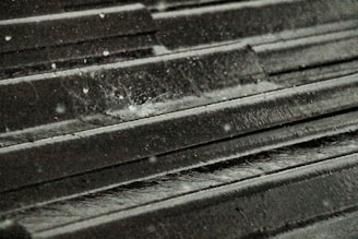 Water droplets beading off a freshly waterproofed roof surface after a rain shower.