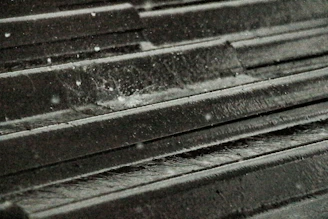 A freshly waterproofed rooftop glistening after rain, highlighting the protective coating.