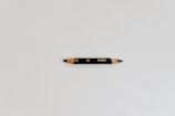 An elegant pencil resting on a finished design blueprint, symbolizing creativity and precision.