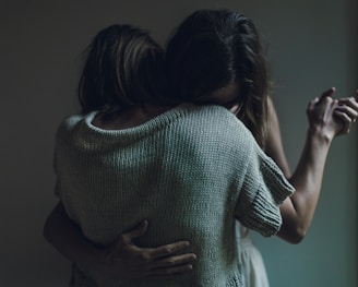 two women hugging each other