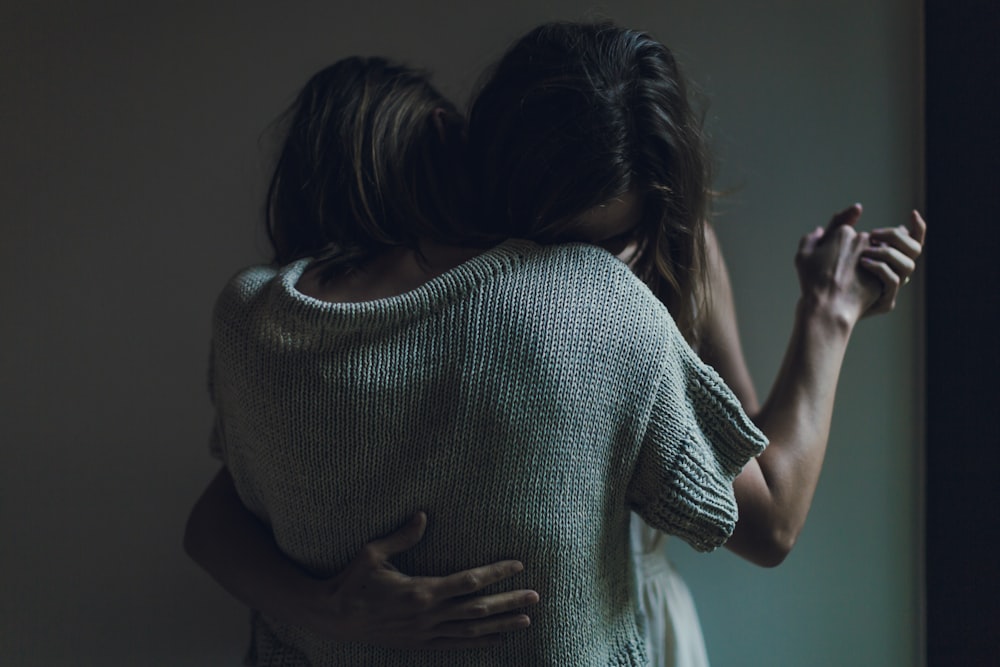 two women hugging each other