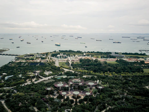 Aerial view of a fleet of ships navigating open waters.