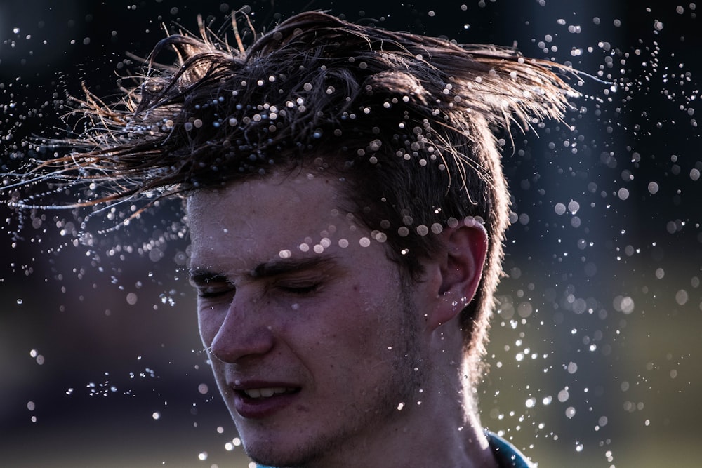 photography of man flipping hair during daytime