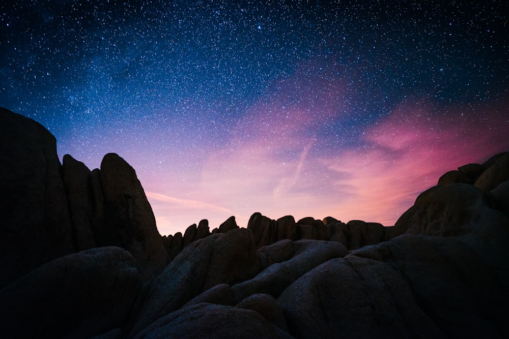 rock mountain during starry night