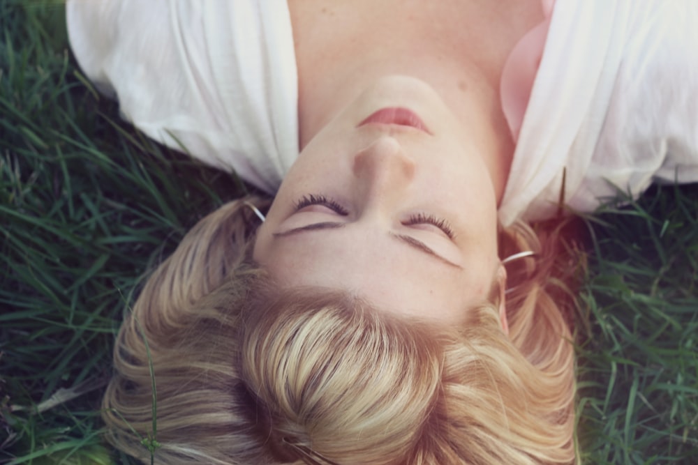 femme couchée sur des herbes vertes