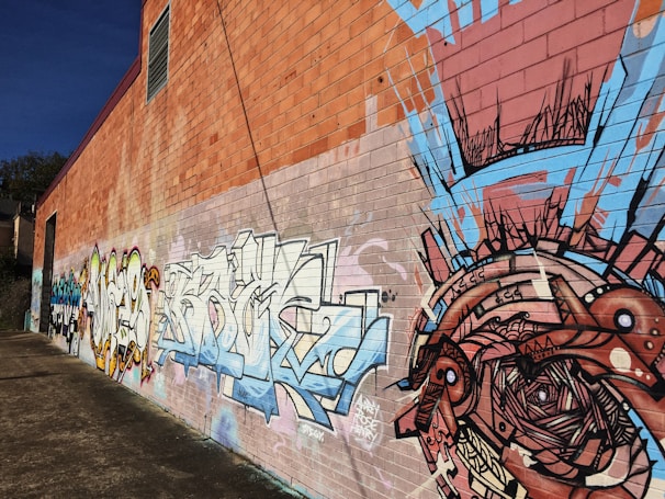 An artistic photo of a mural painted on a brick wall, showcasing local creativity.