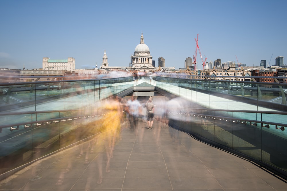 time-lapse photography of people walking on concrete pavement