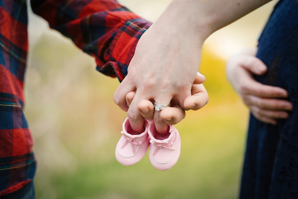 couple holding hands with boots at daytime