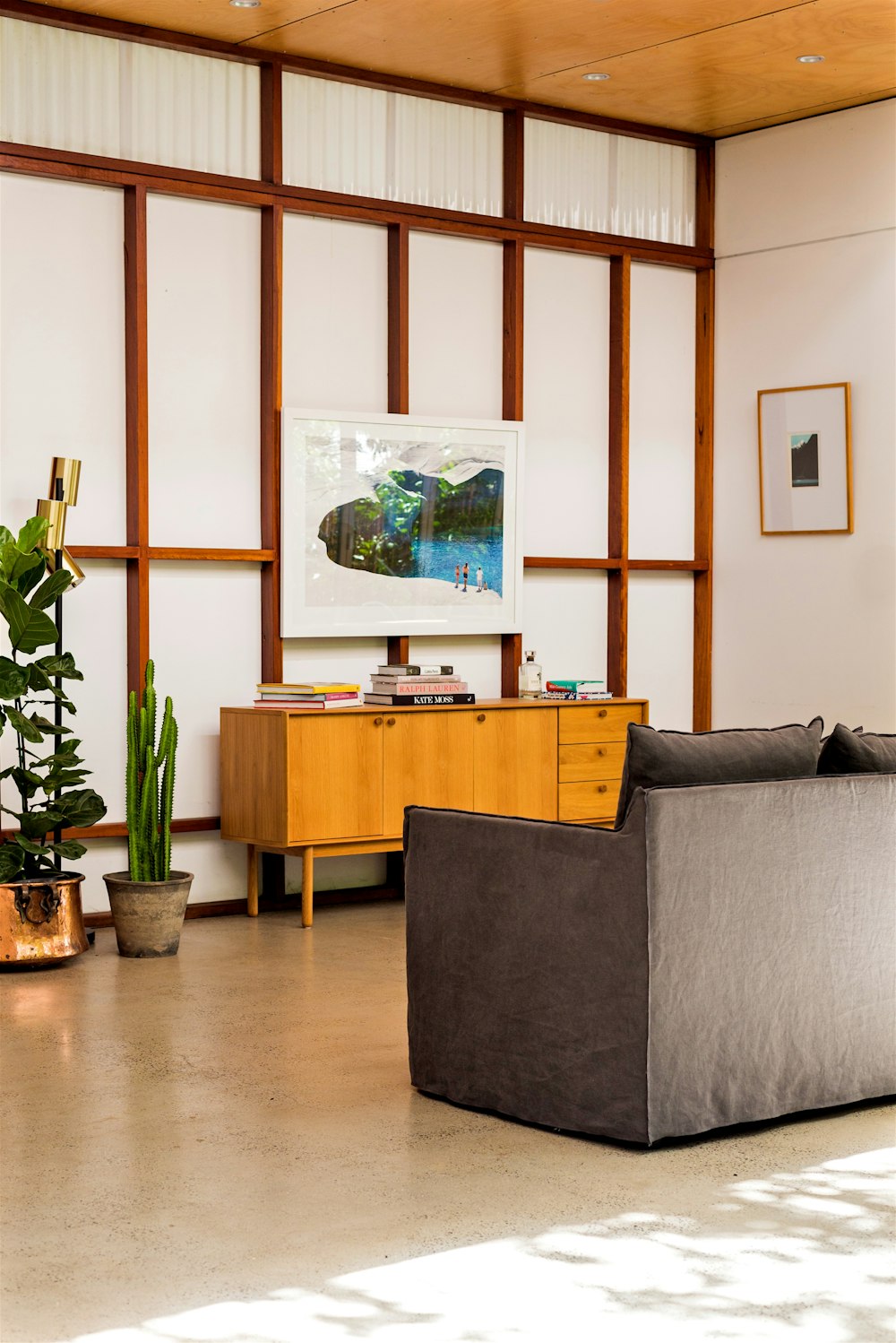 two green potted plants near brown wooden rack