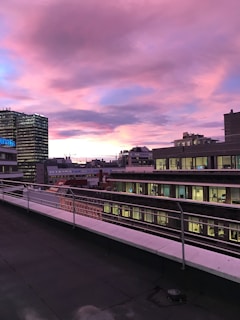 A vibrant photo of an influencer capturing a scenic rooftop view of New York City at sunset.