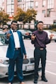 two man standing on front of BMW car