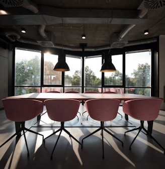 pink dining table with four chairs inside room