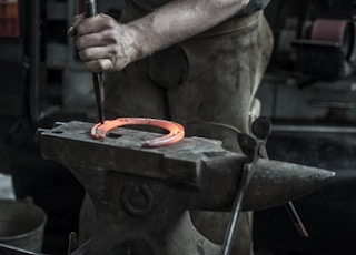 man forging horseshoe