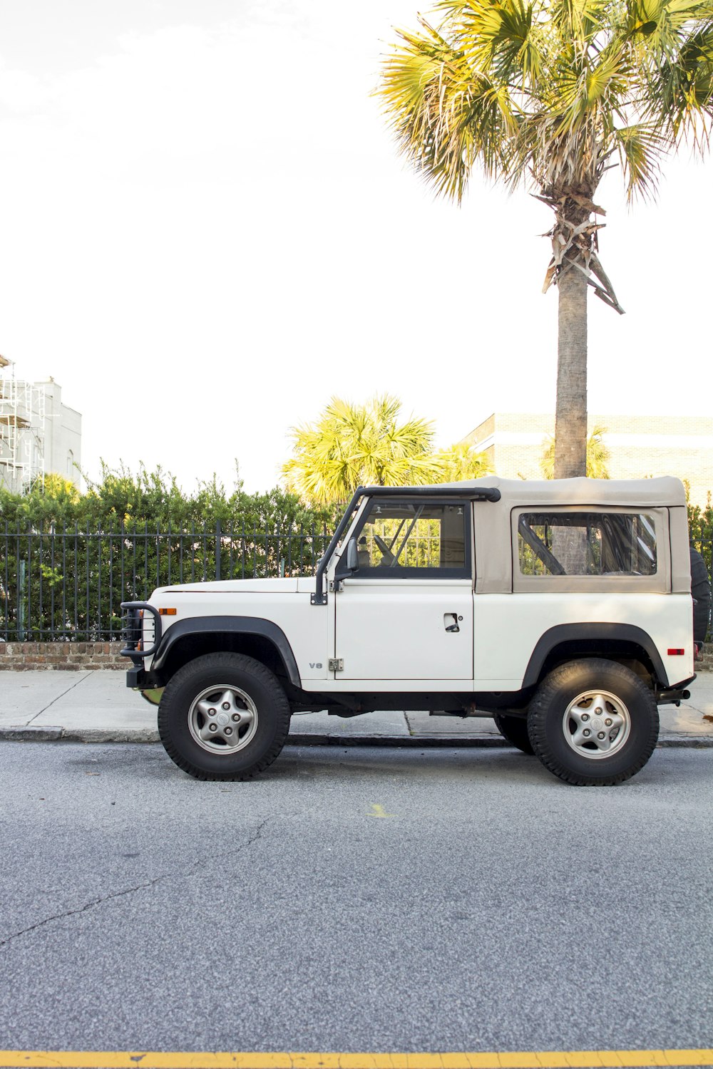 a white jeep parked on the side of the road