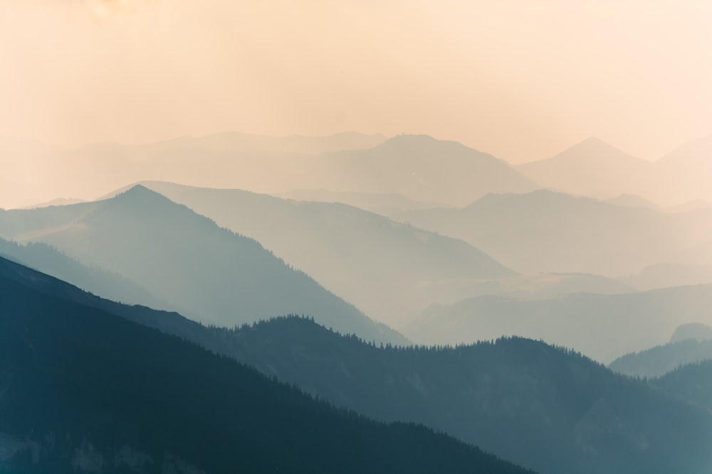 aerial photograph of a mountain covered with fogs