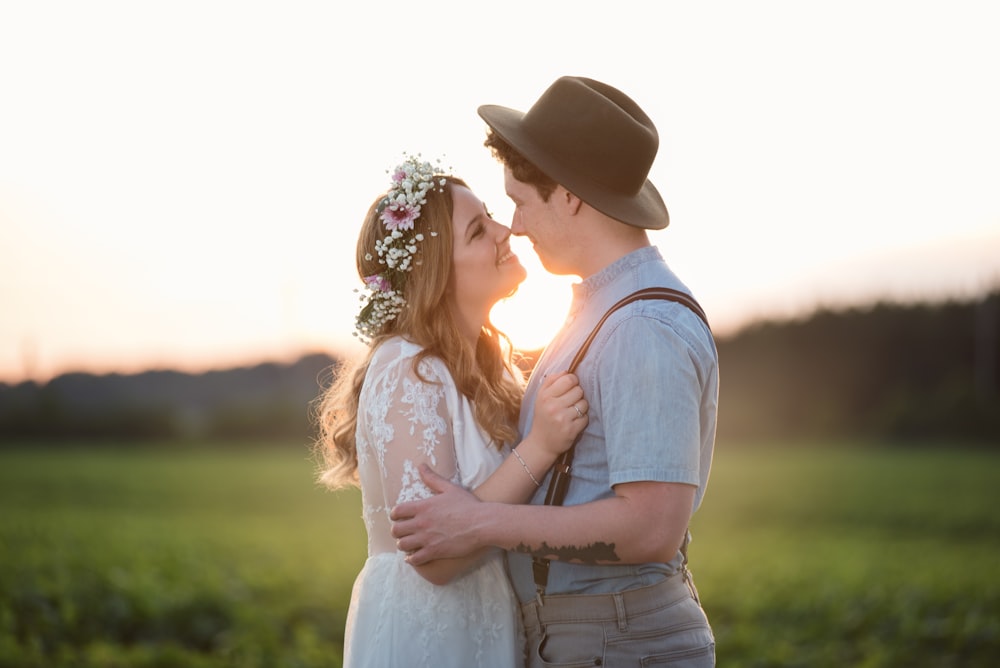 couple facing each other with green grass background \