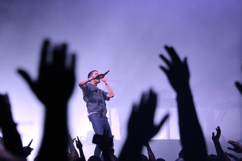 man singing on stage