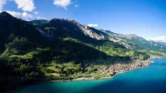 landscape photography of mountains surrounded by body of water