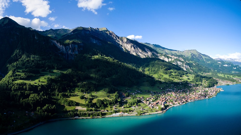 landscape photography of mountains surrounded by body of water