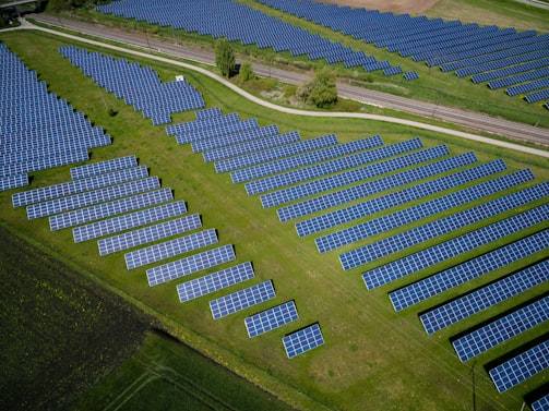 aerial photography of grass field with blue solar panels