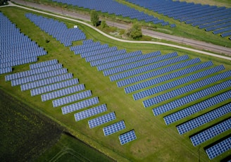 aerial photography of grass field with blue solar panels