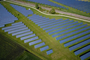 aerial photography of grass field with blue solar panels