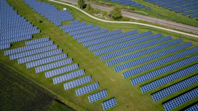 aerial photography of grass field with blue solar panels