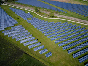 aerial photography of grass field with blue solar panels