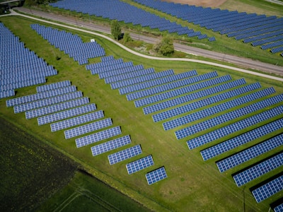 aerial photography of grass field with blue solar panels