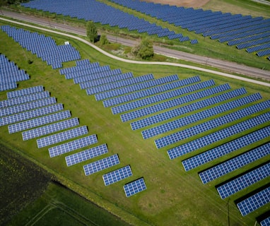 aerial photography of grass field with blue solar panels