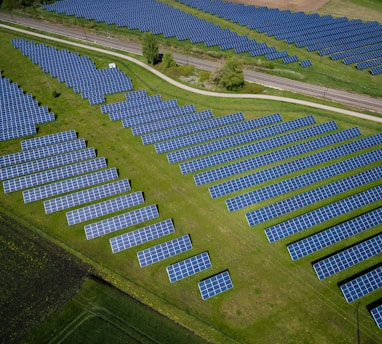 aerial photography of grass field with blue solar panels