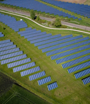 aerial photography of grass field with blue solar panels