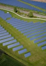 aerial photography of grass field with blue solar panels