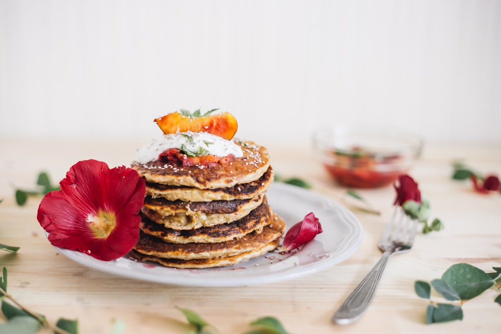 pancakes on plate beside fork