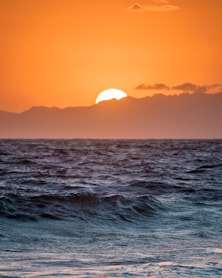 body of water during sunset
