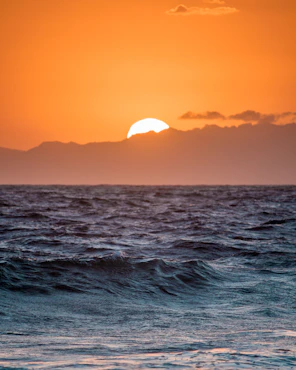 body of water during sunset