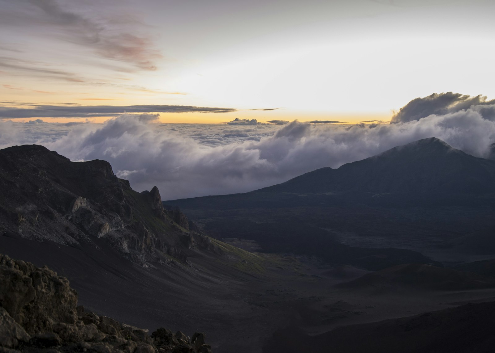 Sunrise light over the volcanic crater and sea of clouds at Haleakalā on Maui