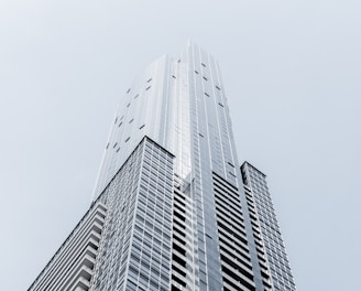 A tall skyscraper in Toronto against a pale blue sky