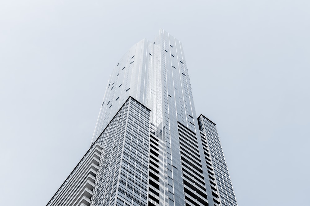 A tall skyscraper in Toronto against a pale blue sky