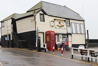 A welcoming race headquarters building at Sideshore, Exmouth, with runners chatting nearby.