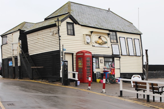 A welcoming race headquarters building at Sideshore, Exmouth, with runners chatting nearby.