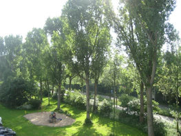 Outdoor garden area with children playing safely under supervision.
