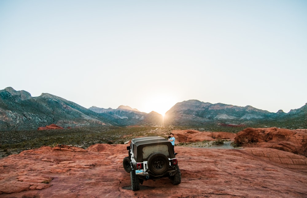 person standing near black off-road vehicle outdoors