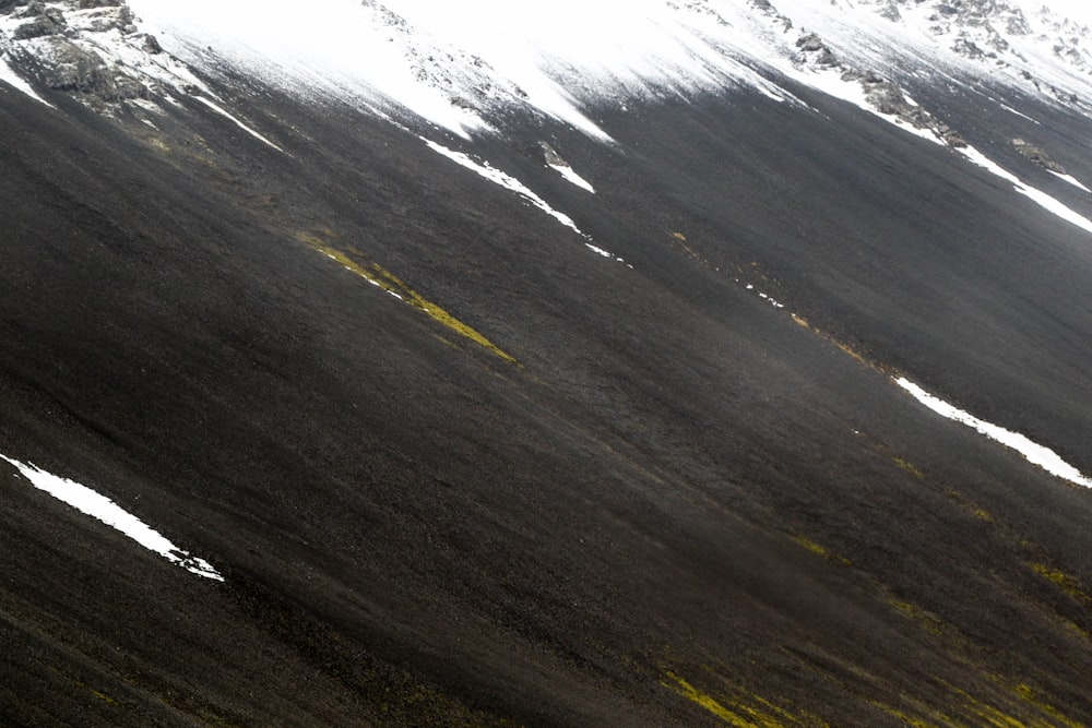 a person riding a snowboard down a snow covered slope