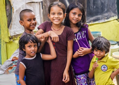 A group of cheerful characters posing for a photo with kids.