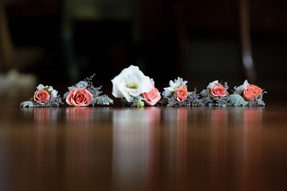 pink and white rose flowers on brown panel