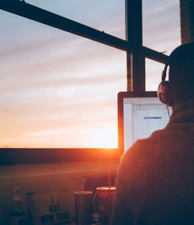 man sitting facing monitor